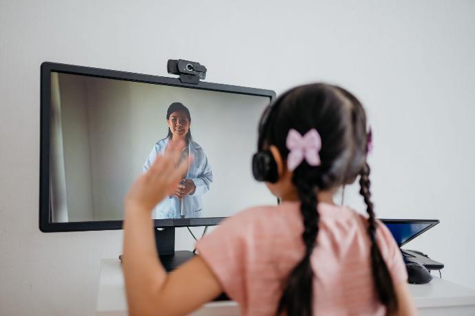 Young child meeting with a remote doctor online