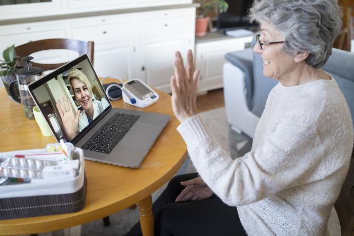 Doctor meeting with an elderly patient remotely