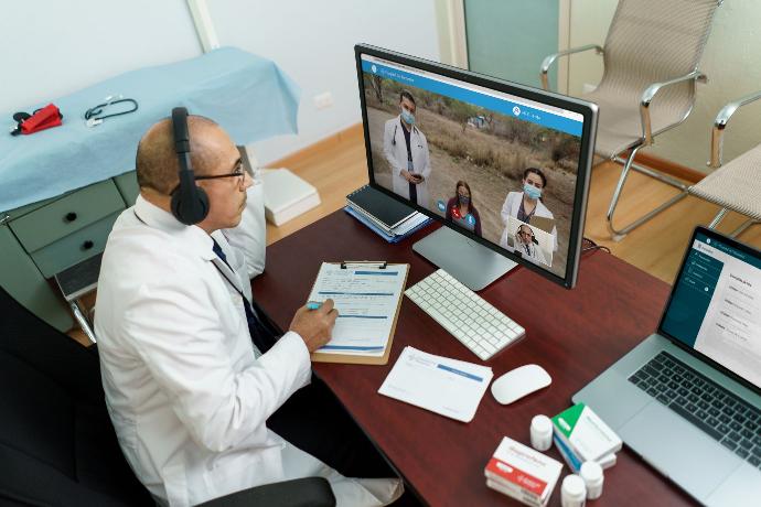 Doctor talking to patients online in a rural location