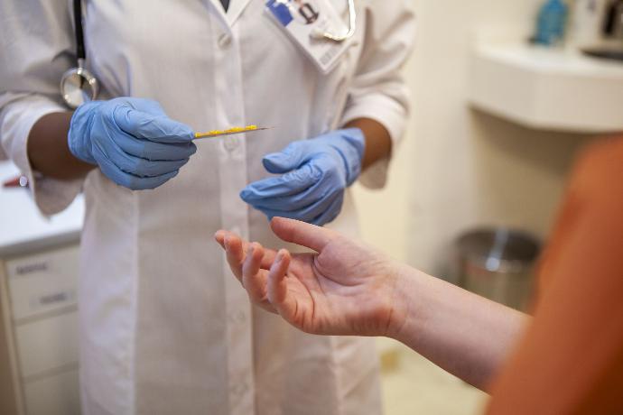 Doctor handing inmate antibiotics
